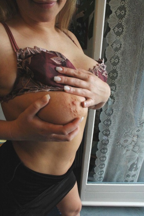 Voluptuous blonde Zdenka K undresses and shows off her natural knockers & ass