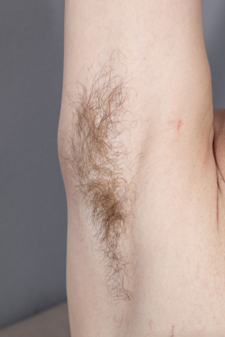 Mature amateur Nimfa Mannay shows her saggy tits and hairy armpits and twat