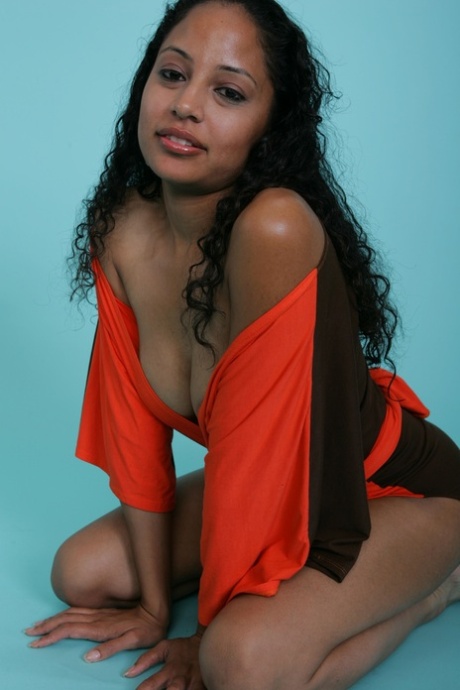 Sexy ebony babe strikes a gorgeous smile while flashing her juicy tits