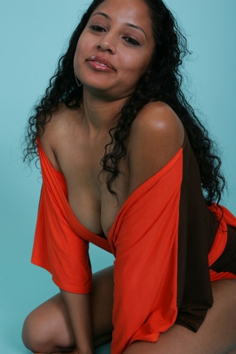 Sexy ebony babe strikes a gorgeous smile while flashing her juicy tits