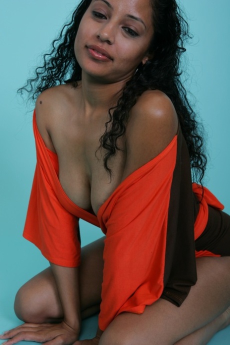 Sexy ebony babe strikes a gorgeous smile while flashing her juicy tits