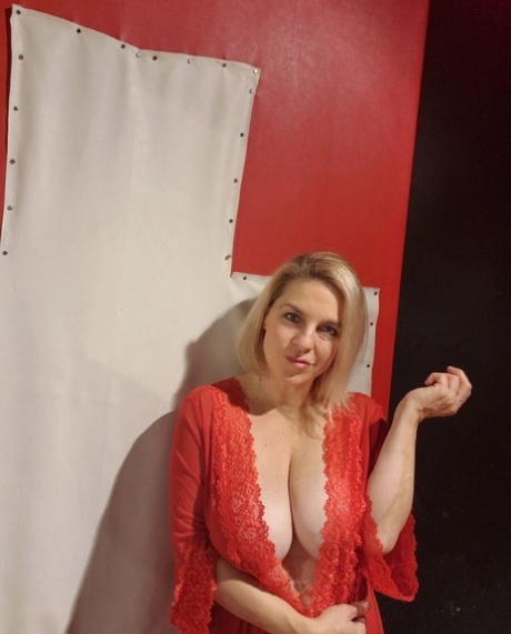 Mature seductress shows her hot cleavage & massages her big boobs