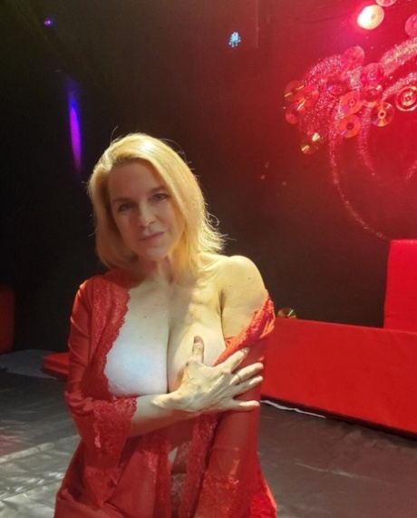 Mature seductress shows her hot cleavage & massages her big boobs